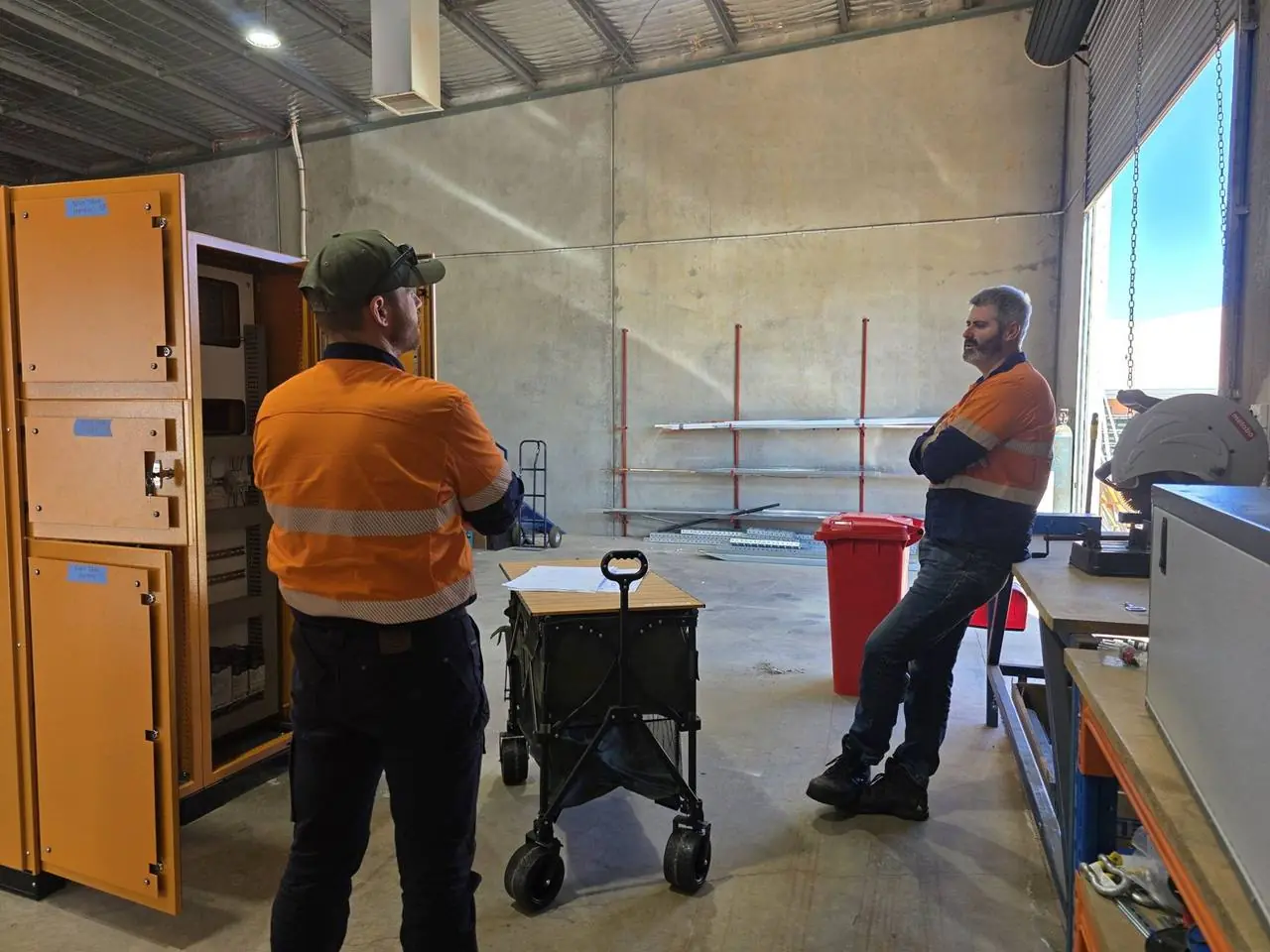 The AMC team with a switchboard in the workshop