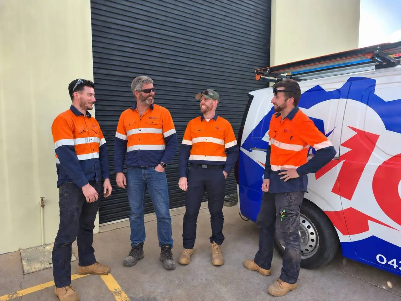 The AMC Electrical & Automation team in hi-vis beside the company van